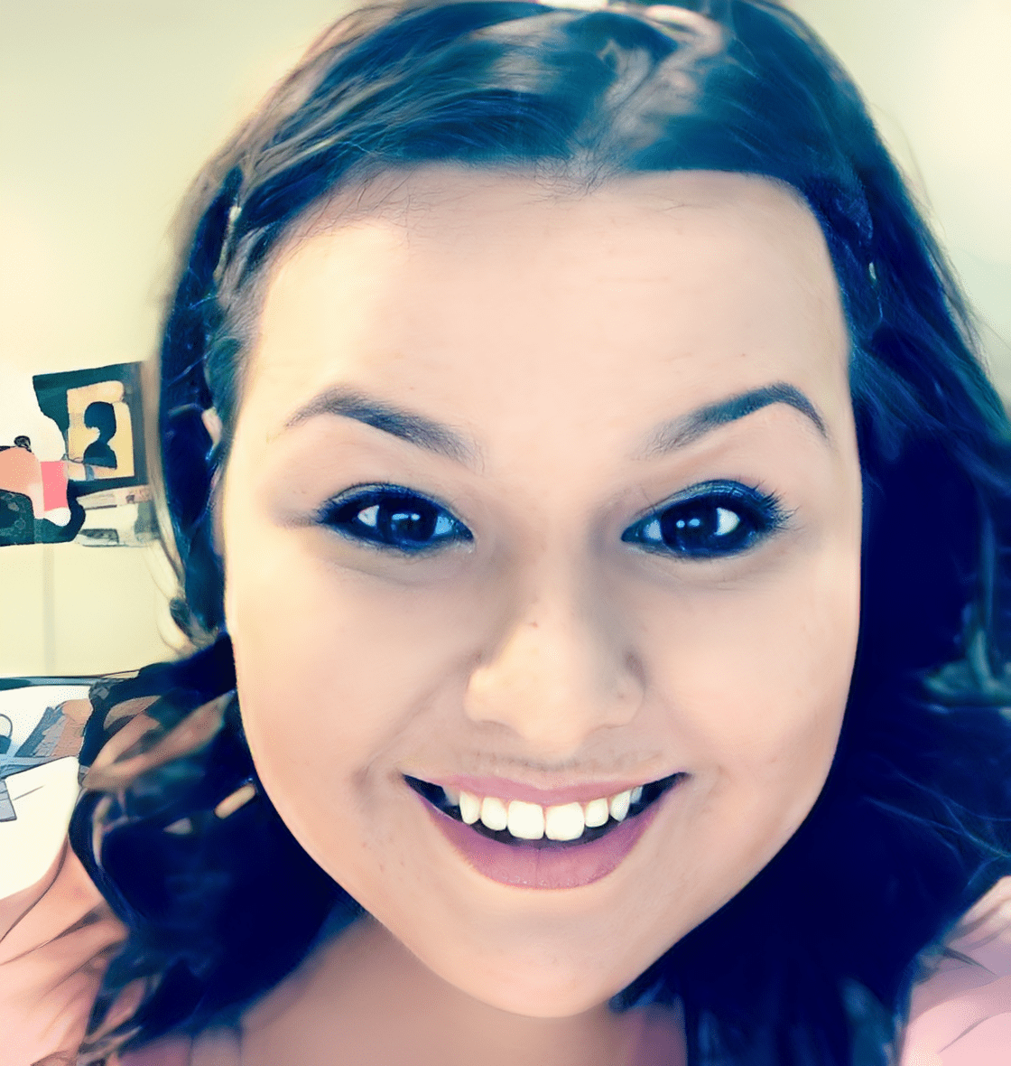 Smiling woman with dark hair indoors