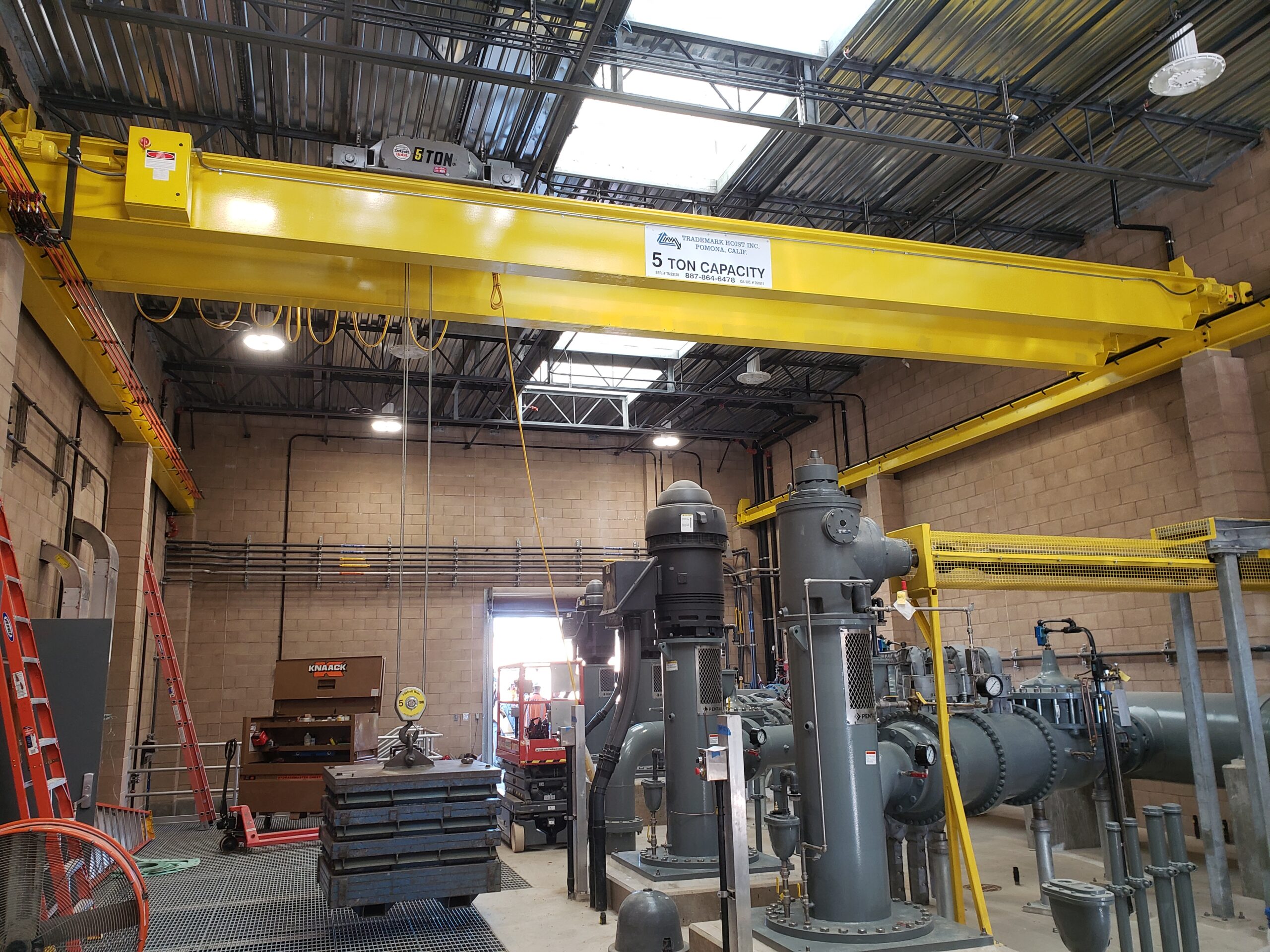 Yellow crane inside a factory workshop