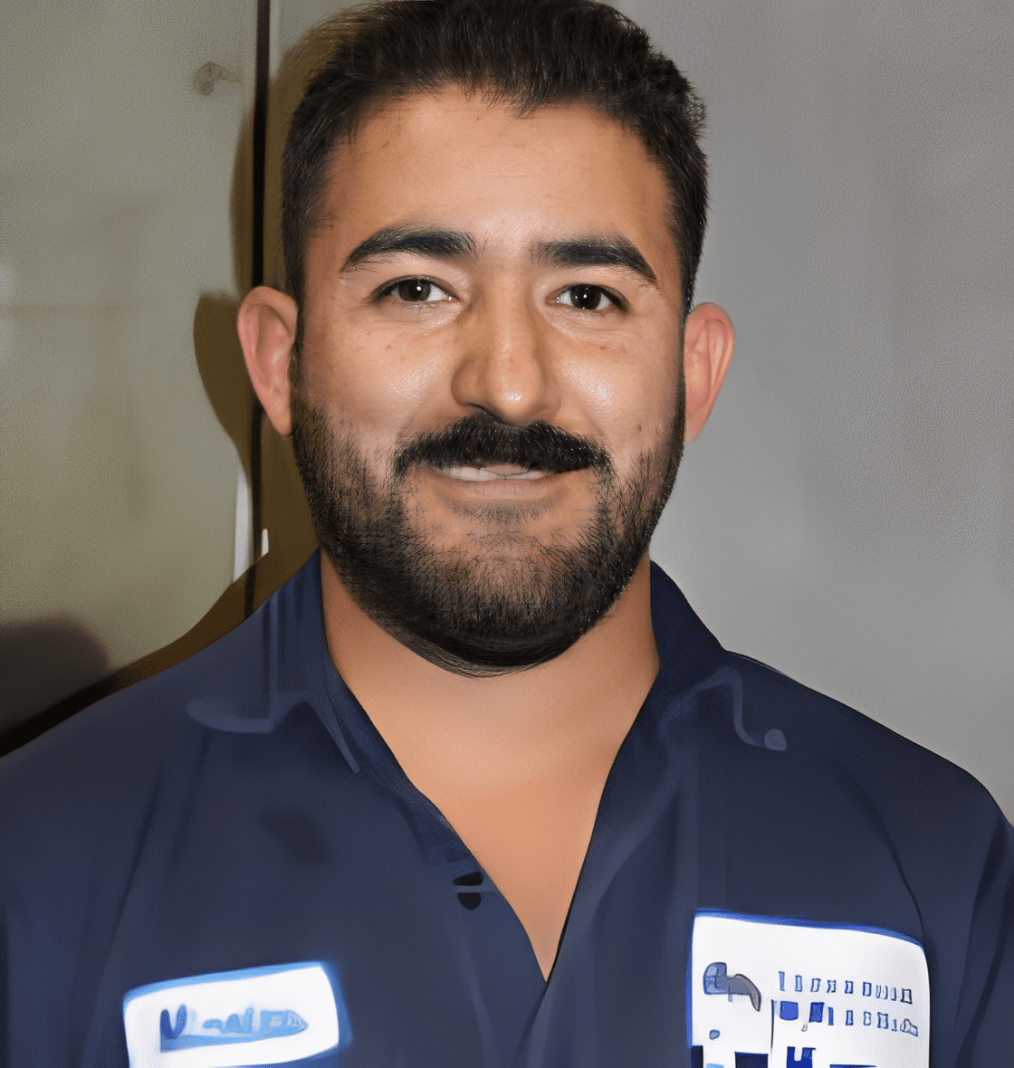Man smiling in work uniform