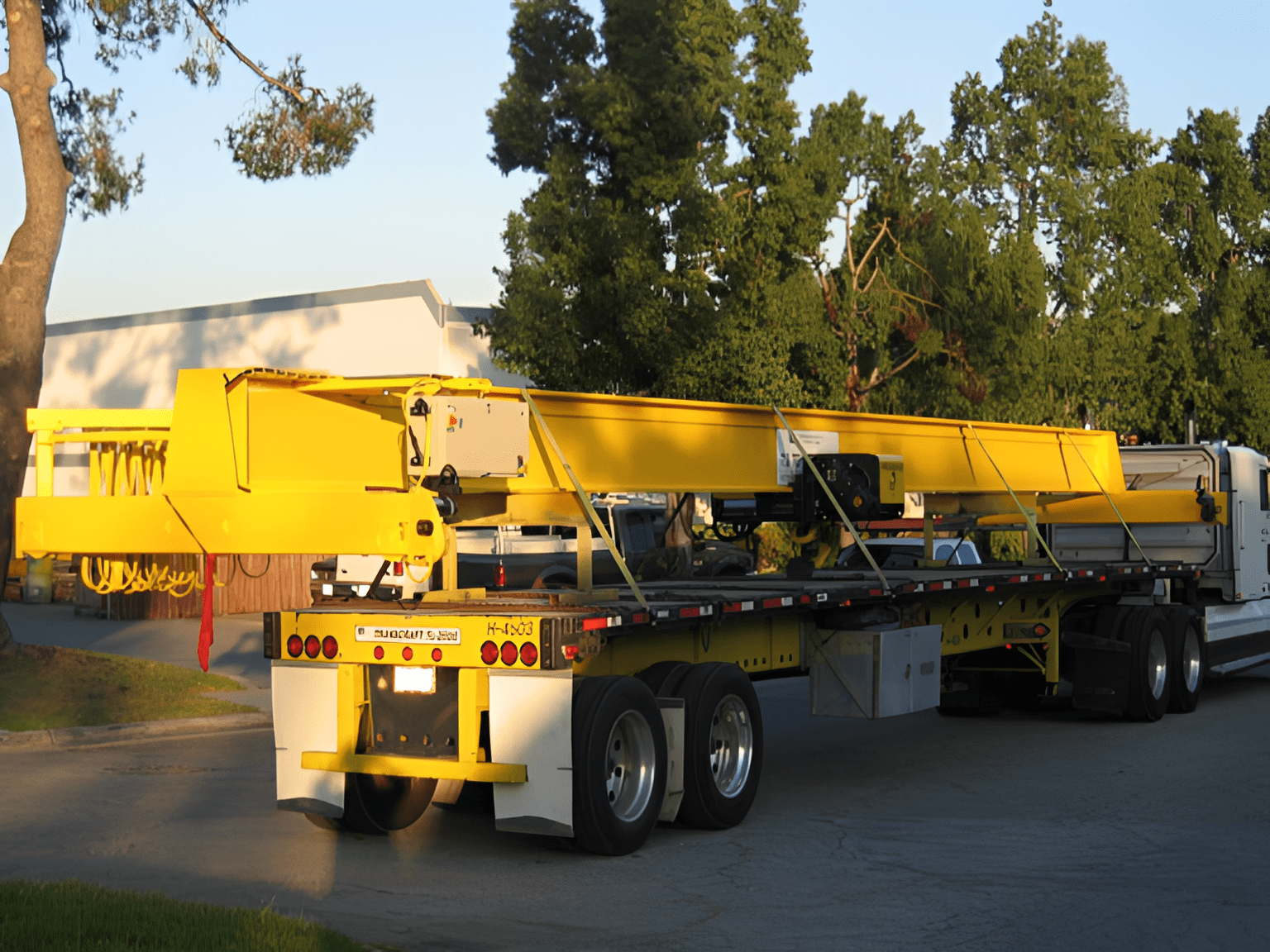 Yellow crane on flatbed trailer