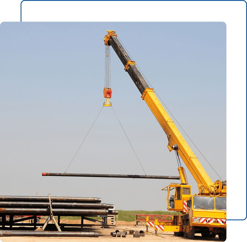 Heavy-duty crane moving large steel pipe