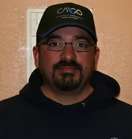 Person in dark hoodie and hat